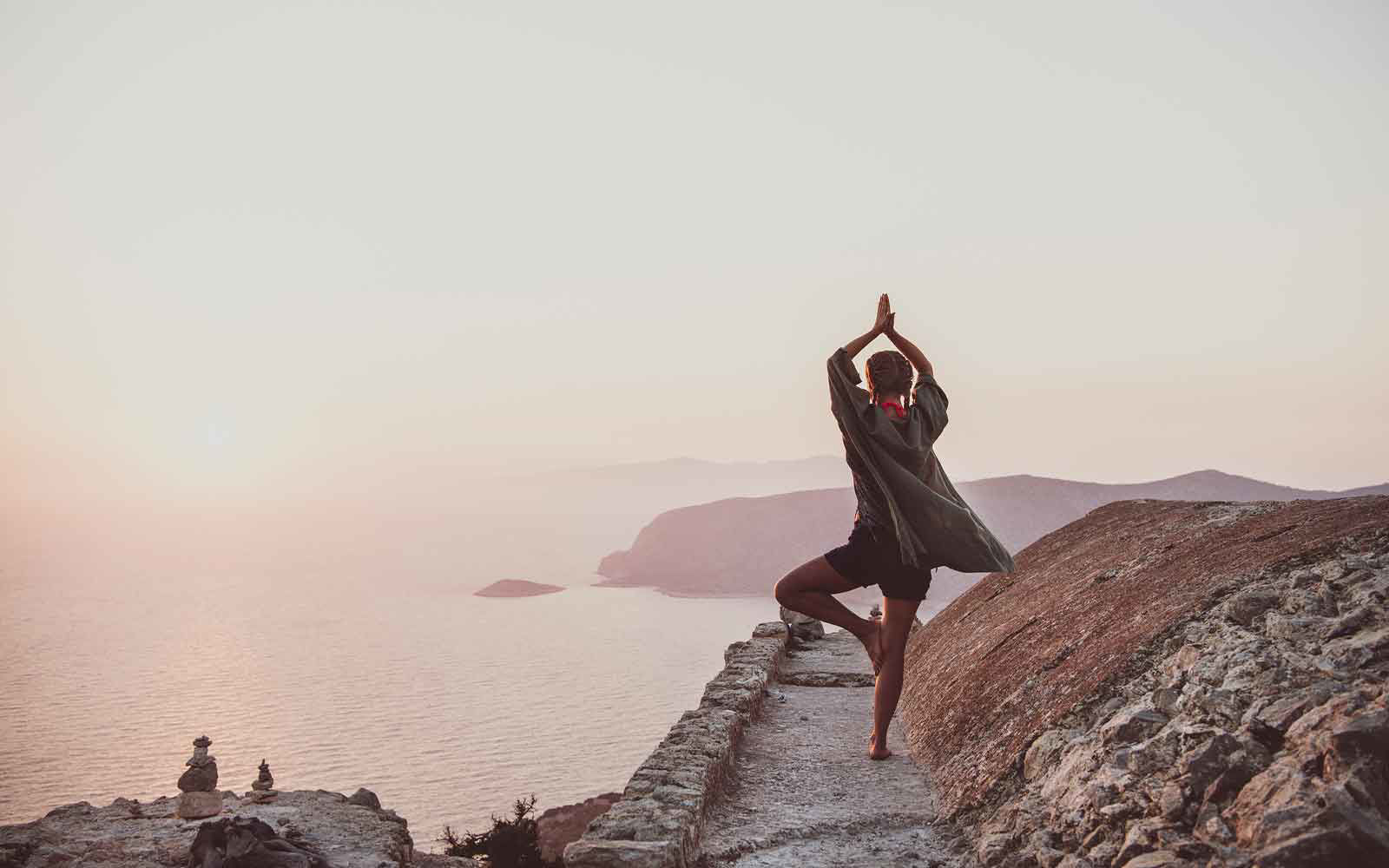 woman doing yoga at sunset