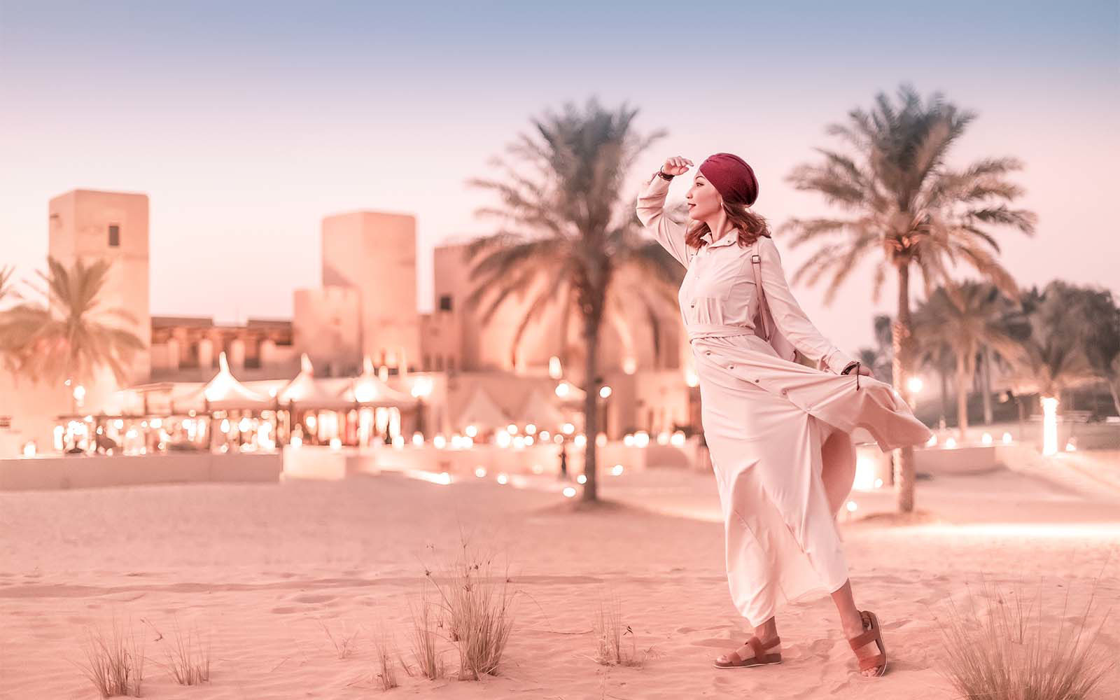 woman looking in distance with desert city behind her